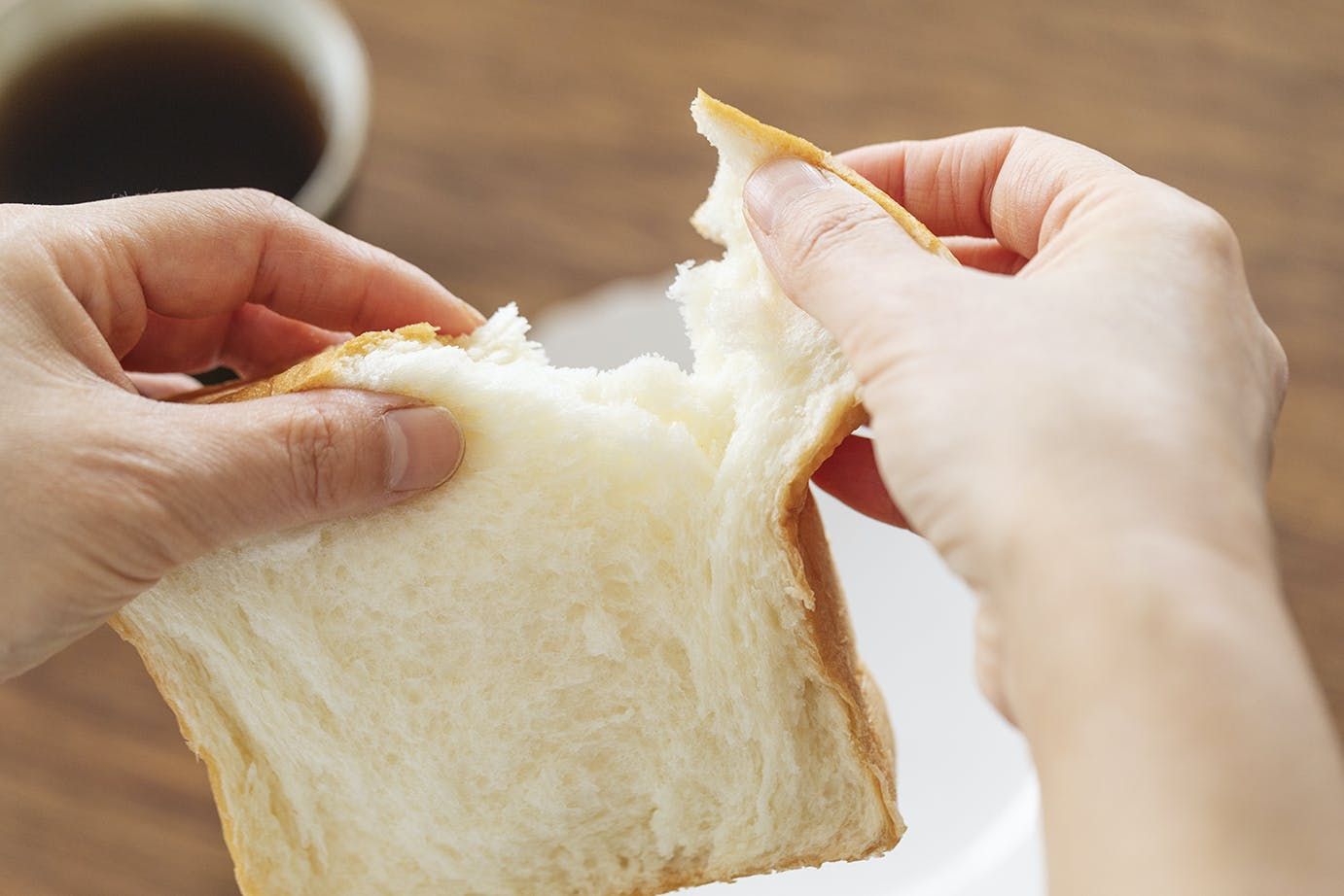 Tearing a small piece of shokupan bread